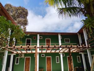a green house with a pergola at Pousada Kaa - Natureza e Sossego em Itacaré in Itacaré +37 photos