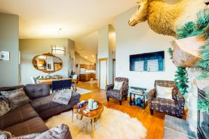 a living room with a couch and a table at Tree Tops 13 in Big White