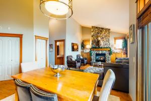 a living room with a wooden table and a couch at Tree Tops 13 in Big White