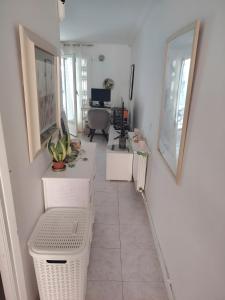 an office with white walls and a hallway with a desk at Apartamento Irlulan in Platja  d'Aro