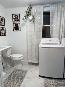 Un baño blanco con inodoro y lavabo. en 3 Bed Bath with yard and Fire Pit- Charming Small Town Exploring, en Bremen 33 fotos más