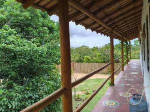 a porch of a house with a wooden pergola at Kitnets ESPELHO a 160 metros da Praia do Espelho in Praia do Espelho
