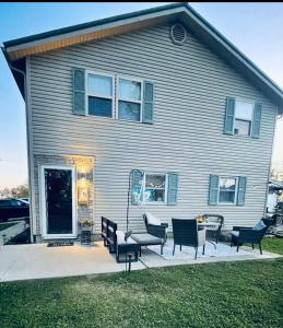 a house with chairs and a table in front of it at 1 BR Cozy Apartment with Fire Pit Short walk to town in Nappanee +34 photos