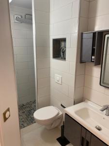 a small bathroom with a toilet and a sink at La petite racine in Sainte-Marie