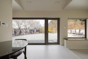 a room with a glass table and a view of a park at 양평스테이 Private Stay Near Seoul - Entire House Just for You 