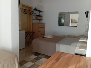 a bedroom with a bed and a mirror at B&B Villa Sofia in Novoli
