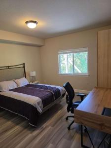a bedroom with a bed and a desk and a window at 2 Beds and 1 bath upgraded modern lower level home in NW Portland in Portland