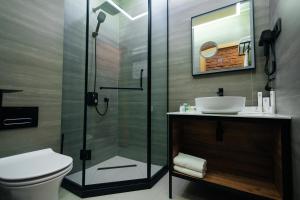 a bathroom with a shower and a toilet and a sink at Samovar in Petropavlovsk
