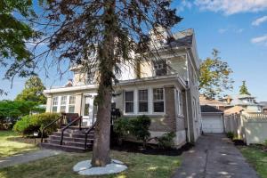 a house with a tree in front of it at The Buffalo Loft in Buffalo