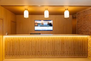 a bar in a restaurant with a tv on the wall at Samovar in Petropavlovsk