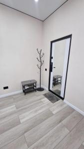 a white room with a table and a mirror at Апартаменты в ЖК Атамура in Karagandy