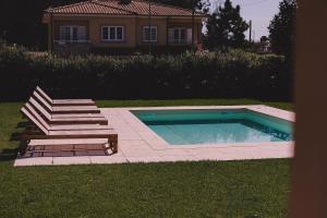 a swimming pool in a yard with stairs and a house at Casa Pacata, Beachside Escape in Labruge