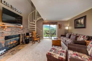 a living room with a couch and a fireplace at TeeTop Getaway by Avada Properties in Pittman Center