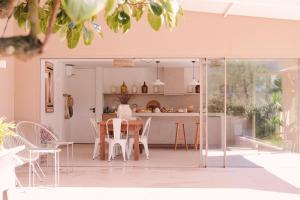 a kitchen and dining room with a table and chairs at Casa Pacata, Beachside Escape in Labruge
