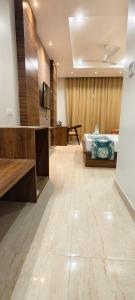 a hotel room with a bed and a television in a room at Hotel Kartik Palace in Varanasi