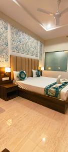 a bedroom with a large bed in a room at Hotel Kartik Palace in Varanasi