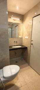 a bathroom with a toilet and a sink at Hotel Kartik Palace in Varanasi