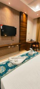 a hotel room with a bed with towels on it at Hotel Kartik Palace in Varanasi