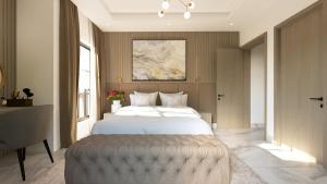a bedroom with a large bed with a large ottoman at Aurelia Apartments in Mama