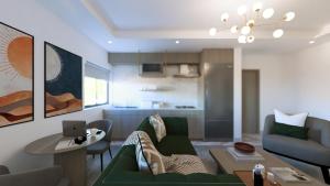a living room with a green couch and a table at Aurelia Apartments in Mama