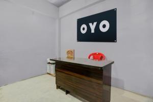 een bureau in een kamer met een bord aan de muur bij SPOT ON Anmay in Phāphāmau