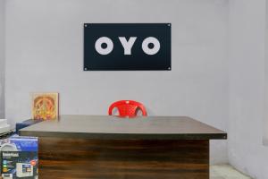 een tafel met een stoel en een bord aan de muur bij SPOT ON Anmay in Phāphāmau