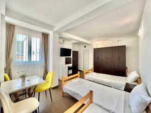 a hotel room with two beds and a table at Hotel Lobo Budva in Budva