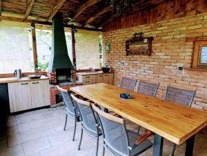 a kitchen with a wooden table and chairs at Chata Radim in Radim