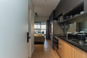 a kitchen with a sink and a counter top at Bauhaus Vista 360° - Piscina Rooftop in Sao Paulo +33 photos