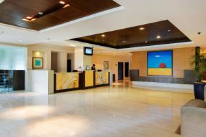 a lobby with a large screen in a building at Vibe By The LaLiT Traveller in Faridabad