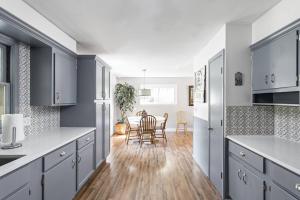 a kitchen with gray cabinets and a dining room at 4Bedroom 2 Bath Home in Arts District-Smoky Row A in Carmel