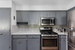 a kitchen with gray cabinets and a stove top oven at 4Bedroom 2 Bath Home in Arts District-Smoky Row A in Carmel +28 photos