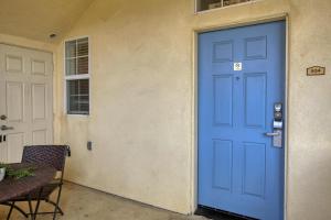 a blue door on a building with a table at Pacific Plaza #504 - Heart of Oceano - 1BdrmD-King in Oceano +20 photos