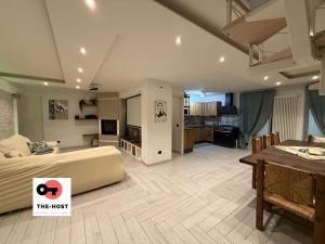 a large bedroom with a bed and a dining room at Large apartment with garden and cinema room in Giussano