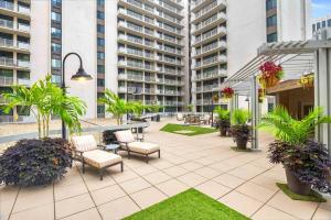 a patio with chairs and tables in a building at A Few Steps From Airport - Stylish Apt in Addison Heights +16 photos