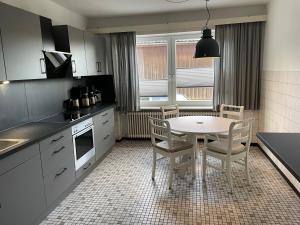 a kitchen with a table and chairs in a kitchen at Landhaus Zur Eiche in Sittensen