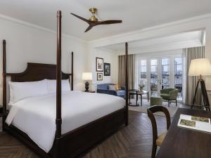 a bedroom with a bed and a living room at Sofitel Legend Casco Viejo, Panama City in Panama City
