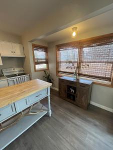 a kitchen with a table and some windows at The Cowboy Corral in Casper