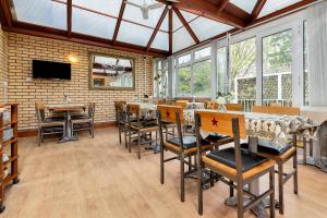a dining room with a table and some chairs at Shelford Lodge in Cambridge