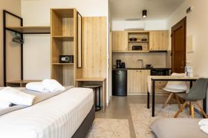 a hotel room with two beds and a kitchen at Helios Sivota in Sivota