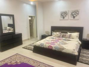 a bedroom with a bed and a large mirror at Luxurious 3-Bedroom Apartment with a swimming pool in Dakar +17 photos