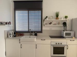 a kitchen with a sink and a window at Vista lake - Kinneret view in Tel Kazir +28 photos