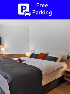 1 dormitorio con 1 cama con una señal de aparcamiento gratuita en Centra Hotel Zurich, en Bassersdorf