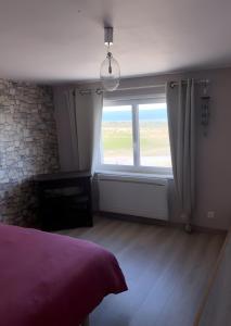 1 dormitorio con ventana grande y cama en Logement Face Mer, en Audinghen 7 fotos más