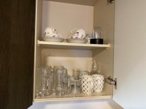a cupboard filled with glasses and other glass items at Serenades - Vacation STAY 17875 in Akiruno +24 photos