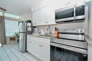 a kitchen with white cabinets and a stainless steel appliances at Park Place Unit 122 in Cedar Key