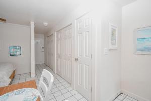 a white room with a bed and a table at Park Place Unit 122 in Cedar Key