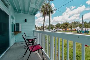 a table and a chair on a porch at Park Place Unit 122 in Cedar Key
