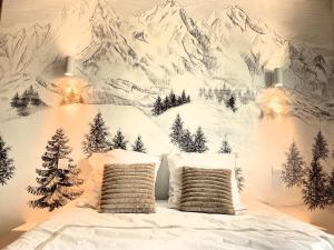 a bedroom with a snowy mountain mural on the wall at Bellevue T1 cozy avec piscine et panorama alpin - proche du lac in La Motte-Servolex