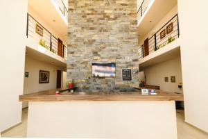 a lobby of a building with a stone wall at Villa Oasis in Ica